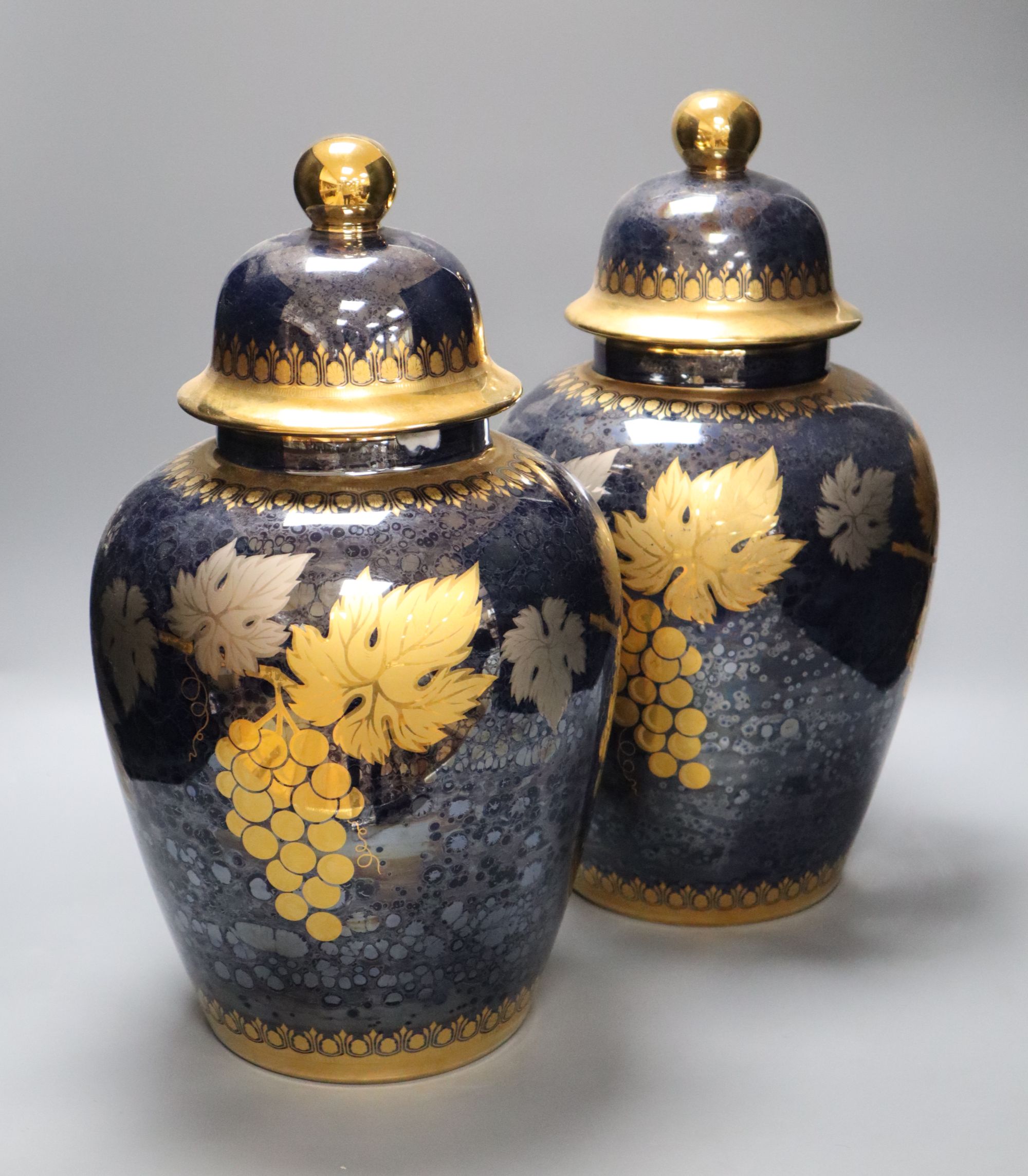 A pair of Artlynsa lustre and gilt decorated vases, height 43cm